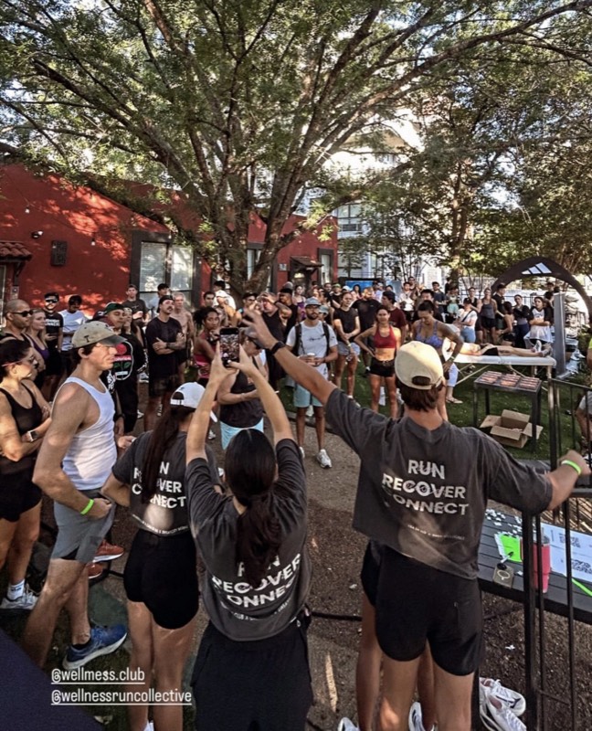 A large crowd gathered outdoors at Casa de Luz for a Sweatcity Run Club event