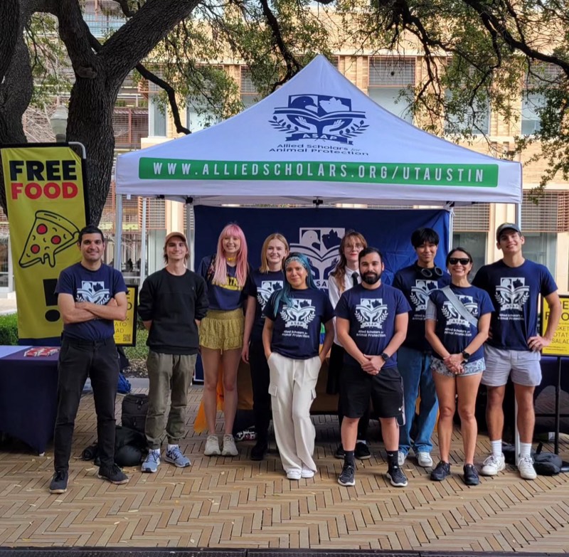Members of Allied Scholars for Animal Protection at an outreach table on the UT Austin campus